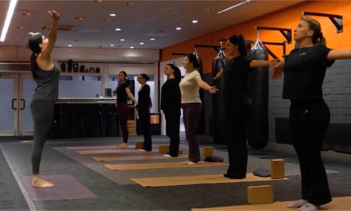 Deelnemer oefent gecontroleerde Pilates bewegingen tijdens groepsles bij BBM Gym Maastricht
